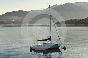 Lonely sailing boat is staying moored at Como lake, Italy