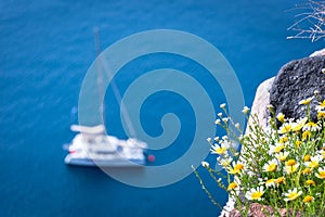 Lonely sailing boat in the vastness of aegean sea, Santorini.