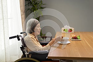 Lonely senior asian woman bored with food