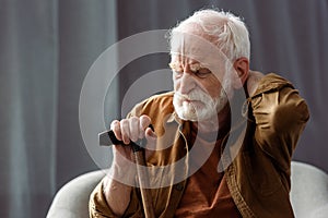 Lonely senior man sitting with closed