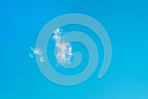 Lonely small cloud on clean blue sky background