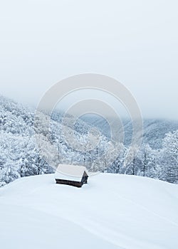 Lonely snowy house in the mountains