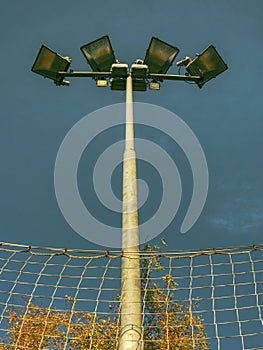 Lonely stadium light or lamp post with Union of light bulb stand alone with clould and blue sky