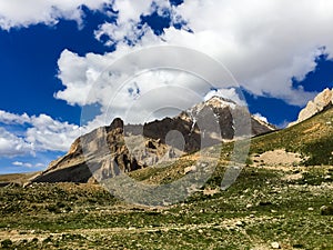 Lonely standing mountain in the background of a cloudy sky.