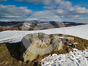 A lonely stone on a hill in winter. CZ. Jizerske hory.