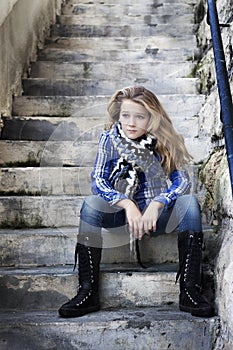 Lonely strong girl sitting on staircase