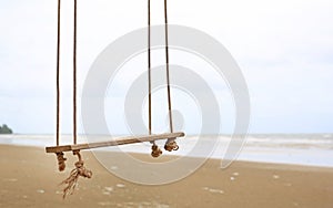 Lonely swing on the beach