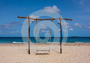 Lonely swing on the beach coast