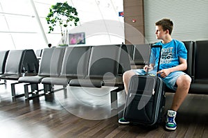 Lonely teen boy at airport