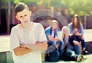 Lonely teenager standing away