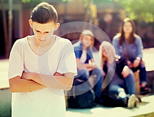 Lonely teenager standing away