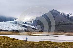 Lonely tourist near Vatnajokull glacial lagoon
