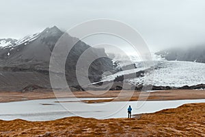 Lonely tourist near Vatnajokull glacial lagoon