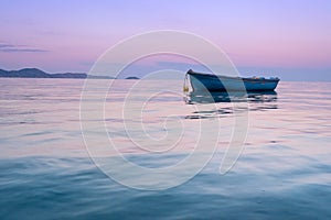 Lonely traditional greek fishing boat on sea water