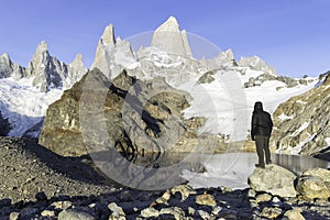 Lonely traveler looking at the snowy mountains in El Chalten - Argentina.