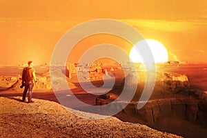 A lonely traveler meets a sunset in the desert. Iran. Dush-e Lut desert