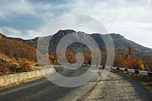 Lonely traveler on the mountain road