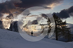 Lonely traveller in Dolomite mountains at winter