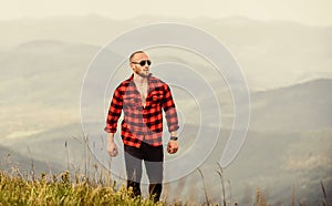 Lonely traveller. sexy macho man in checkered shirt. travelling adventure. hipster fashion. cowboy in hat outdoor