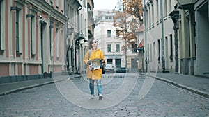 A lonely traveller walks on a street in Riga.