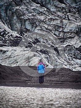 Lonely turist girl near a glacier