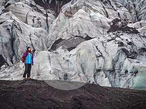 Lonely turist girl near a glacier