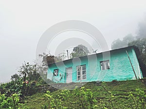 Lonely Turquoise House in White Mountain Fog.