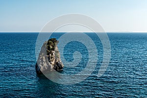 Lonely uninhabited island in blue Ionian Sea