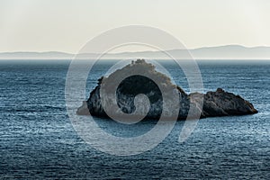 Lonely uninhabited island in blue Ionian Sea