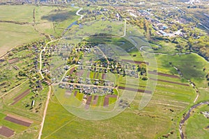 Lonely village on a plain with a river, aerial view