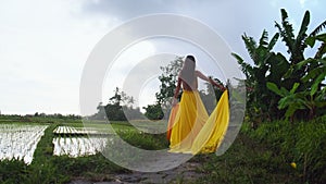 Lonely walk of an elegant woman in long dress