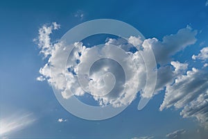 Lonely white cumulus cloud in a blue spring sky. Nature background