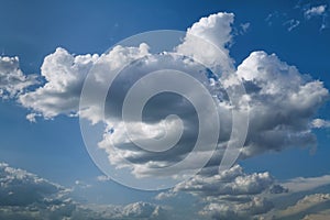 Lonely white cumulus cloud in a blue spring sky. Nature background