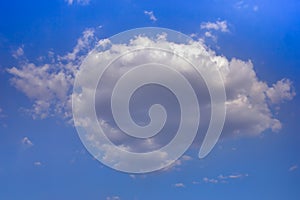 Lonely white cumulus cloud in a blue spring sky. Nature background