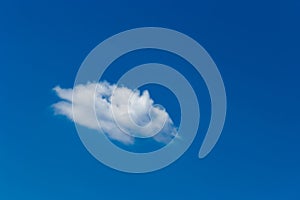 Lonely white little cloud against a blue sky natural background