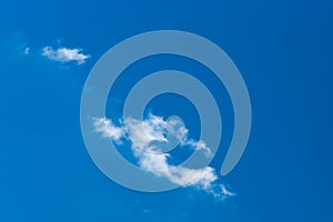 Lonely white little cloud against a blue sky natural background