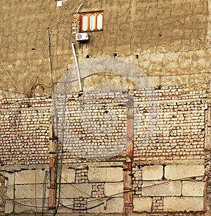 Lonely window in grungy half destroyed wall of a building