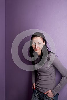 Lonely woman grieves on purple background