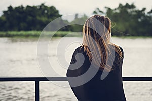 Lonely woman looking at the river