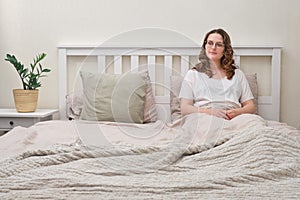 A lonely woman is lying alone in an bed. Female bedroom with an empty pillow