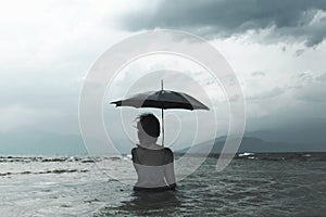 Lonely woman meditating looking at infinity in the rain and thunderstorm