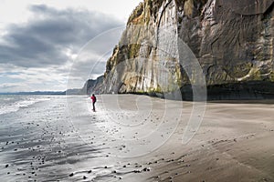 Lonely woman photographer on a sandy beach