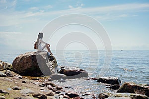 Lonely Woman Sitting and looking at Sea.