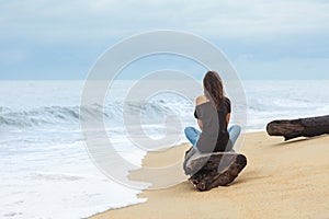 Lonely woman sitting on the tropical beach