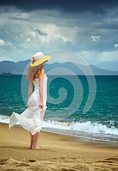 Lonely woman standing at the sea