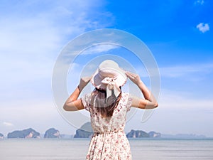 Lonely Woman in summer vacation wearing straw hat and beach dress