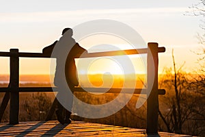 Lonely woman at sunrise. Solitude concept, alone in forest photo