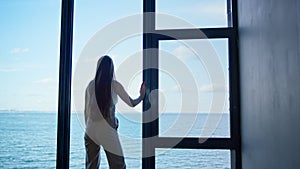 Lonely woman thinking problems at panorama window. Upset businesswoman crying