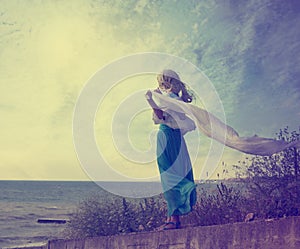 Lonely Woman in Turquoise Dress with Waving Scarf