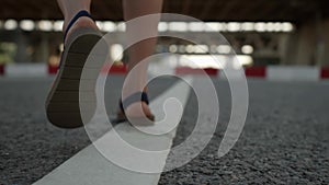 lonely woman is walking on road in city, closeup of feet, lost, straying and wandering